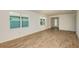 Open-concept living room with wood-look tile flooring and plenty of natural light at 5831 Sw 87Th Ave, Ocala, FL 34481