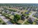 Aerial view showcases a home surrounded by mature landscaping, a fenced backyard, and views of the surrounding neighborhood at 6272 Cornerstone Dr, Lakeland, FL 33813