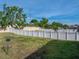 Spacious backyard with green grass, a disc golf basket, and a white vinyl perimeter fence at 6272 Cornerstone Dr, Lakeland, FL 33813
