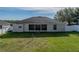 Aerial view of the home's backyard featuring a screened-in patio and lush lawn at 6272 Cornerstone Dr, Lakeland, FL 33813