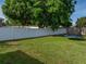 Large backyard with green grass and a white vinyl perimeter fence at 6272 Cornerstone Dr, Lakeland, FL 33813