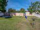 Large backyard featuring green grass, a playset with slide, trampoline, and disc golf basket at 6272 Cornerstone Dr, Lakeland, FL 33813