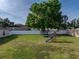 Spacious backyard with green grass, a playset with slide, trampoline, and white vinyl perimeter fence at 6272 Cornerstone Dr, Lakeland, FL 33813