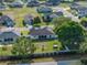 Aerial view of a home with a fenced backyard, a screened lanai, mature trees, and well-kept landscaping at 6272 Cornerstone Dr, Lakeland, FL 33813