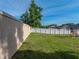 Nice sized backyard with green grass, a playset with slide, and a white vinyl perimeter fence at 6272 Cornerstone Dr, Lakeland, FL 33813