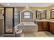 Luxurious bathroom featuring a soaking tub, walk-in shower, and dual vanity sinks for added convenience at 6272 Cornerstone Dr, Lakeland, FL 33813