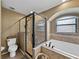 Well-appointed bathroom with a separate shower, soaking tub, and a large window for natural light at 6272 Cornerstone Dr, Lakeland, FL 33813
