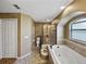 Relaxing bathroom featuring a walk-in shower, soaking tub, and ample space at 6272 Cornerstone Dr, Lakeland, FL 33813