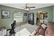 Comfortable bedroom offering natural light, a ceiling fan, and access to kitchen space at 6272 Cornerstone Dr, Lakeland, FL 33813