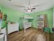 Charming ' bedroom with a bunk bed, hardwood floors, and bright green walls at 6272 Cornerstone Dr, Lakeland, FL 33813