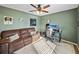 Bedroom featuring a ceiling fan, natural light and a brown couch and office setup at 6272 Cornerstone Dr, Lakeland, FL 33813