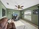 Cozy bedroom with a ceiling fan, a window providing natural light, and a comfortable couch at 6272 Cornerstone Dr, Lakeland, FL 33813