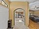 View of a kitchen through an arched doorway in a home featuring neutral walls and tile floors at 6272 Cornerstone Dr, Lakeland, FL 33813