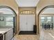 Home foyer with tile flooring, arched entryways, and a view into other living spaces at 6272 Cornerstone Dr, Lakeland, FL 33813