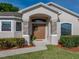 Front entrance featuring a double door entry with stone columns and a green wreath at 6272 Cornerstone Dr, Lakeland, FL 33813