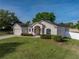 Single Gathering home with manicured lawn, stone accents, and an attached two-car garage on a sunny day at 6272 Cornerstone Dr, Lakeland, FL 33813