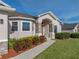 Inviting front porch with stone columns, a welcome sign, and well-maintained landscaping at 6272 Cornerstone Dr, Lakeland, FL 33813