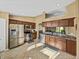 Bright kitchen with stainless steel appliances, tile flooring, and dark wood cabinets at 6272 Cornerstone Dr, Lakeland, FL 33813