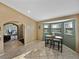 Bright eat-in kitchen with table and stools and view into other rooms through arched doorways at 6272 Cornerstone Dr, Lakeland, FL 33813