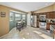 Eat-in kitchen with stainless steel appliances, table with stools, and lots of natural light at 6272 Cornerstone Dr, Lakeland, FL 33813
