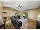 Spacious living room featuring a large sectional sofa, wood flooring, and sliding glass doors at 6272 Cornerstone Dr, Lakeland, FL 33813