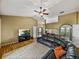 Bright living room with a vaulted ceiling, wood floors, and comfortable seating at 6272 Cornerstone Dr, Lakeland, FL 33813