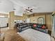 Open-concept living room boasts a corner sectional sofa and wood-look flooring at 6272 Cornerstone Dr, Lakeland, FL 33813