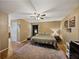 Cozy main bedroom features a comfortable bed, ceiling fan, and warm color tones for a relaxing atmosphere at 6272 Cornerstone Dr, Lakeland, FL 33813