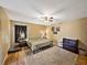 Comfortable main bedroom is decorated with a neutral color palette, ceiling fan, and a plush area rug at 6272 Cornerstone Dr, Lakeland, FL 33813