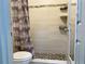 Shower room featuring modern tile, seashell-themed accents, and updated fixtures at 7900 S Orange Blossom Trl # 1099, Orlando, FL 32809