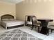 Cozy bedroom featuring a comfortable bed, accent rug, and simple furnishings at 7900 S Orange Blossom Trl # 1099, Orlando, FL 32809