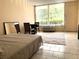 Bright studio bedroom with large windows, tiled floors, and modern amenities at 7900 S Orange Blossom Trl # 1099, Orlando, FL 32809