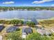 Stunning aerial perspective featuring a waterfront house, revealing its private backyard and the picturesque lake at 917 Shawna Shrs, Haines City, FL 33844