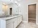 Bright bathroom featuring a double vanity with granite countertop and a walk-in closet at 917 Shawna Shrs, Haines City, FL 33844