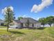 Charming single-story home featuring an attached garage and a lush, green lawn at 917 Shawna Shrs, Haines City, FL 33844