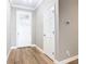Bright and welcoming foyer with wood-look floors, white trim, and neutral paint, creating a clean and modern entrance at 917 Shawna Shrs, Haines City, FL 33844