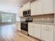 Bright kitchen showcasing white cabinets, granite counters, and stainless steel oven at 917 Shawna Shrs, Haines City, FL 33844