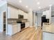 Well-lit kitchen showcasing granite countertops, stainless steel appliances, and wood-look floors, offering a clean aesthetic at 917 Shawna Shrs, Haines City, FL 33844