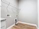 A laundry room featuring a wire shelf, washer/dryer hookups, and light vinyl flooring at 917 Shawna Shrs, Haines City, FL 33844