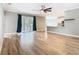 Bright open-concept living room featuring wood-look floors and a view of the kitchen and sliding glass doors at 917 Shawna Shrs, Haines City, FL 33844