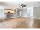 Open-concept living room with wood-look floors connecting the kitchen and foyer, providing a sense of spaciousness and flow at 917 Shawna Shrs, Haines City, FL 33844