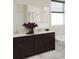 Bathroom featuring marble floors, dark cabinets, dual sinks, and a glass enclosed shower at 1887 Clear Sky Dr, Kissimmee, FL 34744