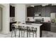 Modern kitchen with dark cabinets, stainless steel appliances, and a large island with seating at 1887 Clear Sky Dr, Kissimmee, FL 34744
