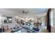 Bright and airy living room with an open floor plan, flowing into dining area and modern kitchen at 1919 Blissful Dr, Kissimmee, FL 34744