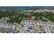 Scenic aerial view of the neighborhood with homes, ponds, a distant lake, and surrounding trees at 272 Pershing St, Bartow, FL 33830