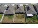 Aerial shot showcasing backyard spaces enclosed with white fences between neighboring homes at 272 Pershing St, Bartow, FL 33830