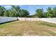 Enclosed backyard featuring a spacious grassy area and a tall white privacy fence at 272 Pershing St, Bartow, FL 33830