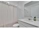 Bright bathroom featuring a granite countertop vanity, toilet, mirror, and shower with white curtain at 272 Pershing St, Bartow, FL 33830