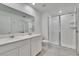 Bright bathroom featuring double sinks, a glass-enclosed shower, and sleek design elements at 272 Pershing St, Bartow, FL 33830