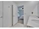 Well-lit bathroom with a door leading to a bedroom, showcasing the vanity and countertop at 272 Pershing St, Bartow, FL 33830